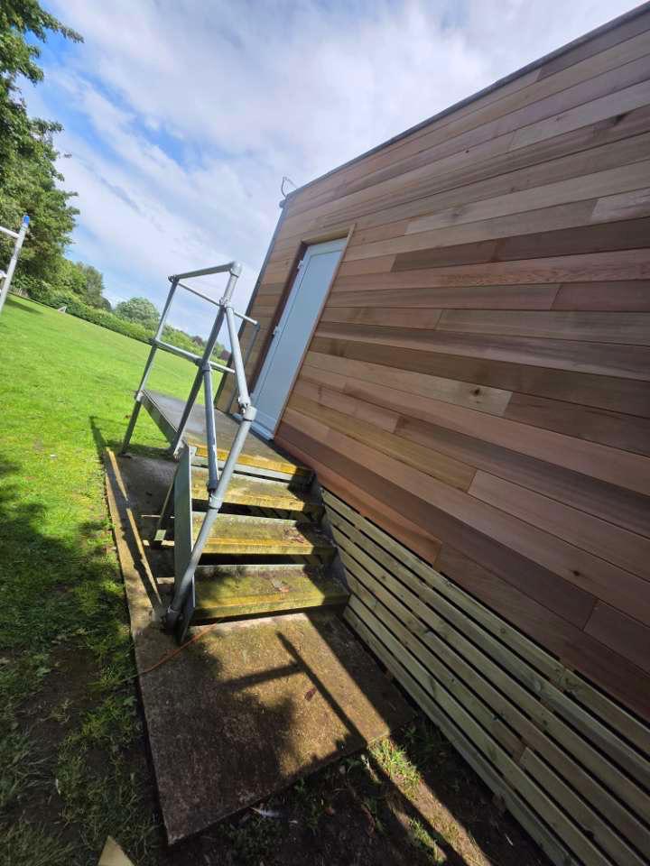 Cedar cladding with entrance steps and access platform